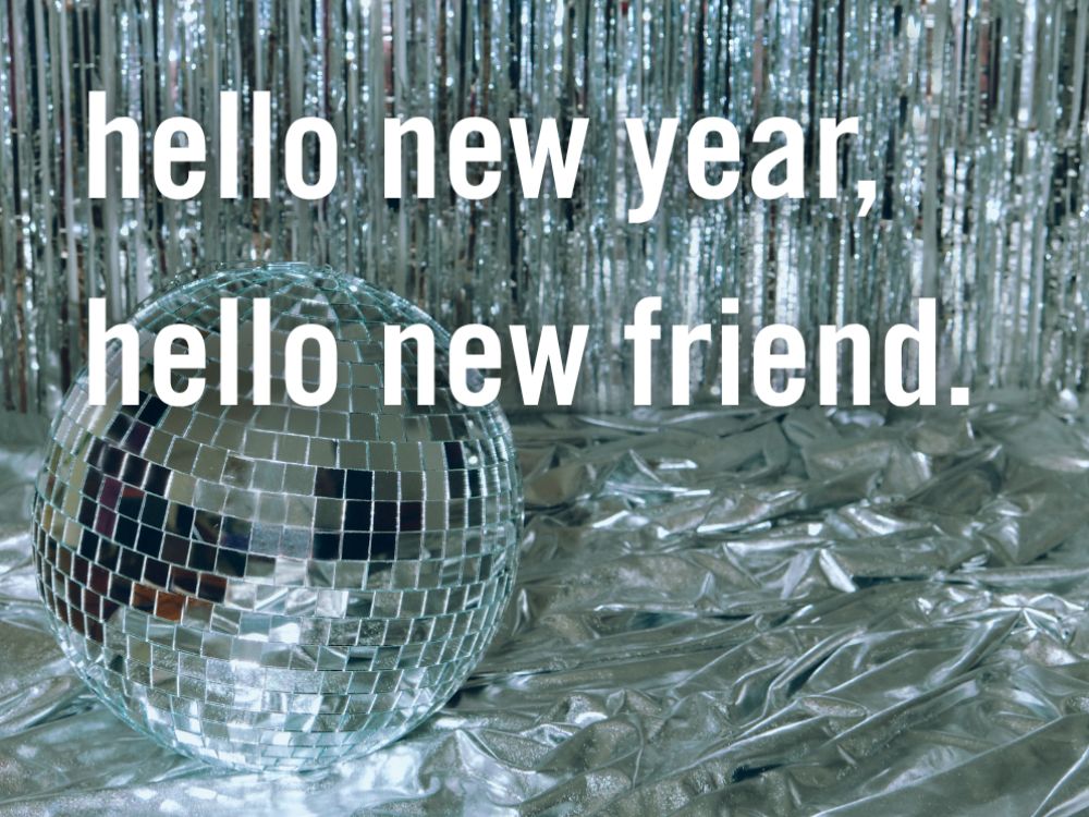 A festive greeting card with "Hello New Year, Hello New Friend" in colorful letters against a celebratory background.