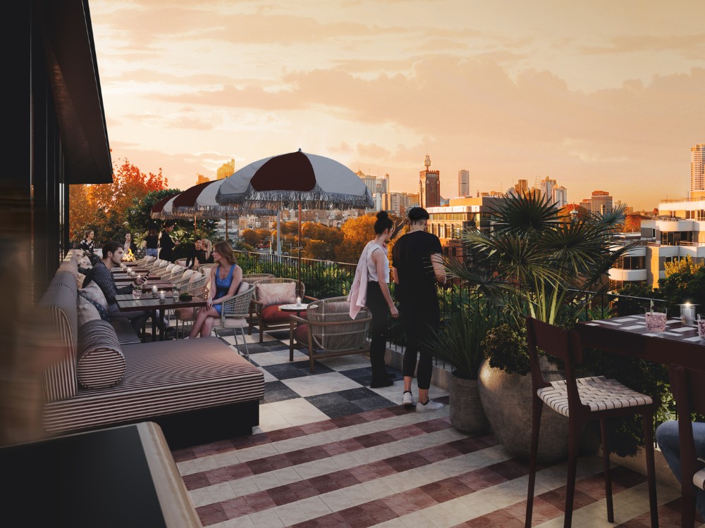 A rooftop bar scene at sunset, featuring guests dining among plants and umbrellas, overlooking a city skyline.