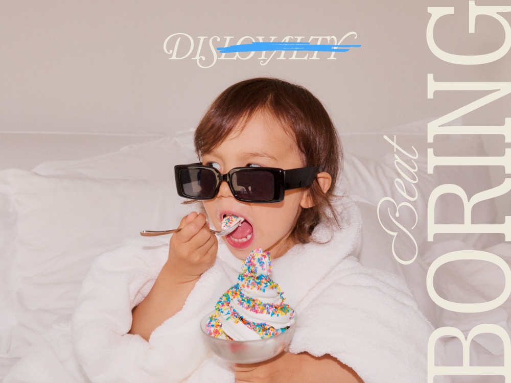 A child in a fluffy white robe wearing sunglasses enjoys a bowl of colorful sprinkles topped dessert, with playful text overlay.