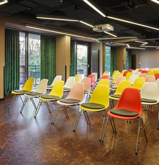 A spacious room filled with rows of chairs arranged for a gathering or meeting.